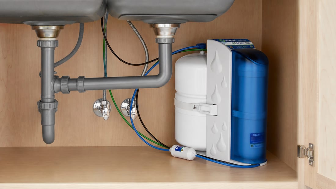 Under-sink reverse osmosis drinking water system installed in a kitchen cabinet